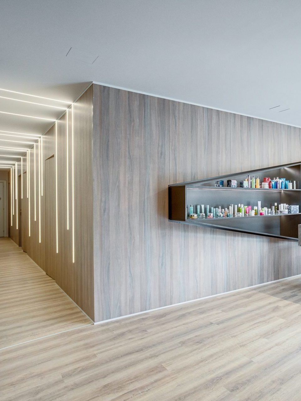 The lit corridor and product wall inside the Beauty in the City salon