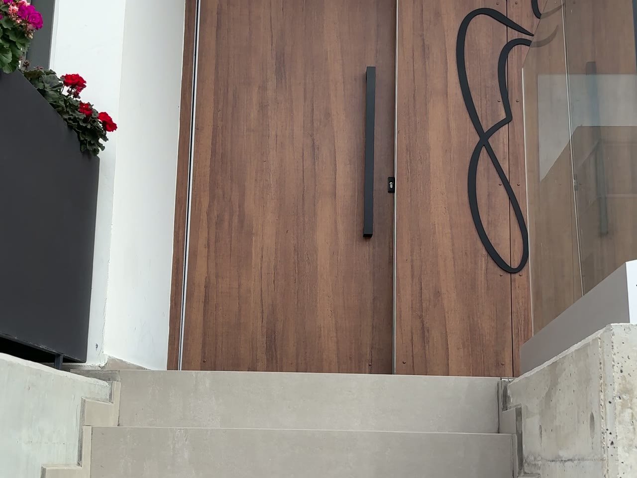 The wooden entrance door at Beauty in the City with its line-art figure